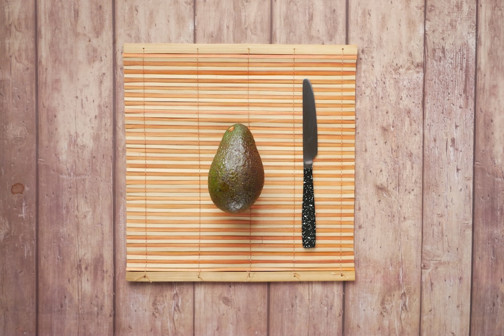 green avocado fruit on brown wooden table
