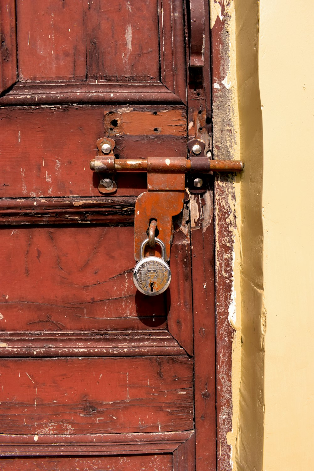 brown wooden door with padlock