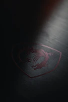 A sleek, high-tech resistance emblem etched onto a metallic surface under dim lighting.