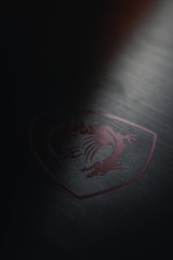 An abstract machine blueprint overlaid with crimson blade accents on a deep black background.