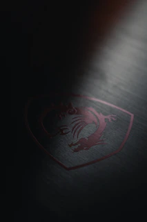 A sleek, high-tech resistance emblem etched onto a metallic surface under dim lighting.