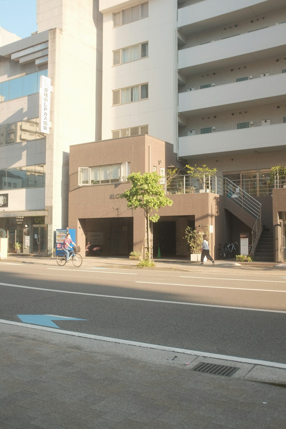 people walking on sidewalk near building during daytime