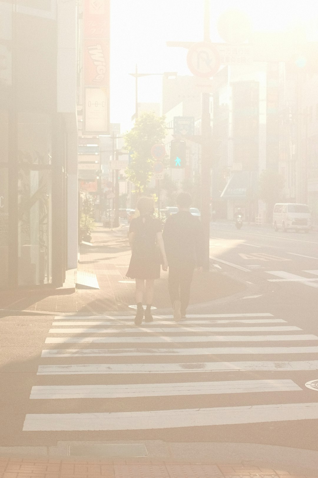 man in black coat walking on pedestrian lane during daytime