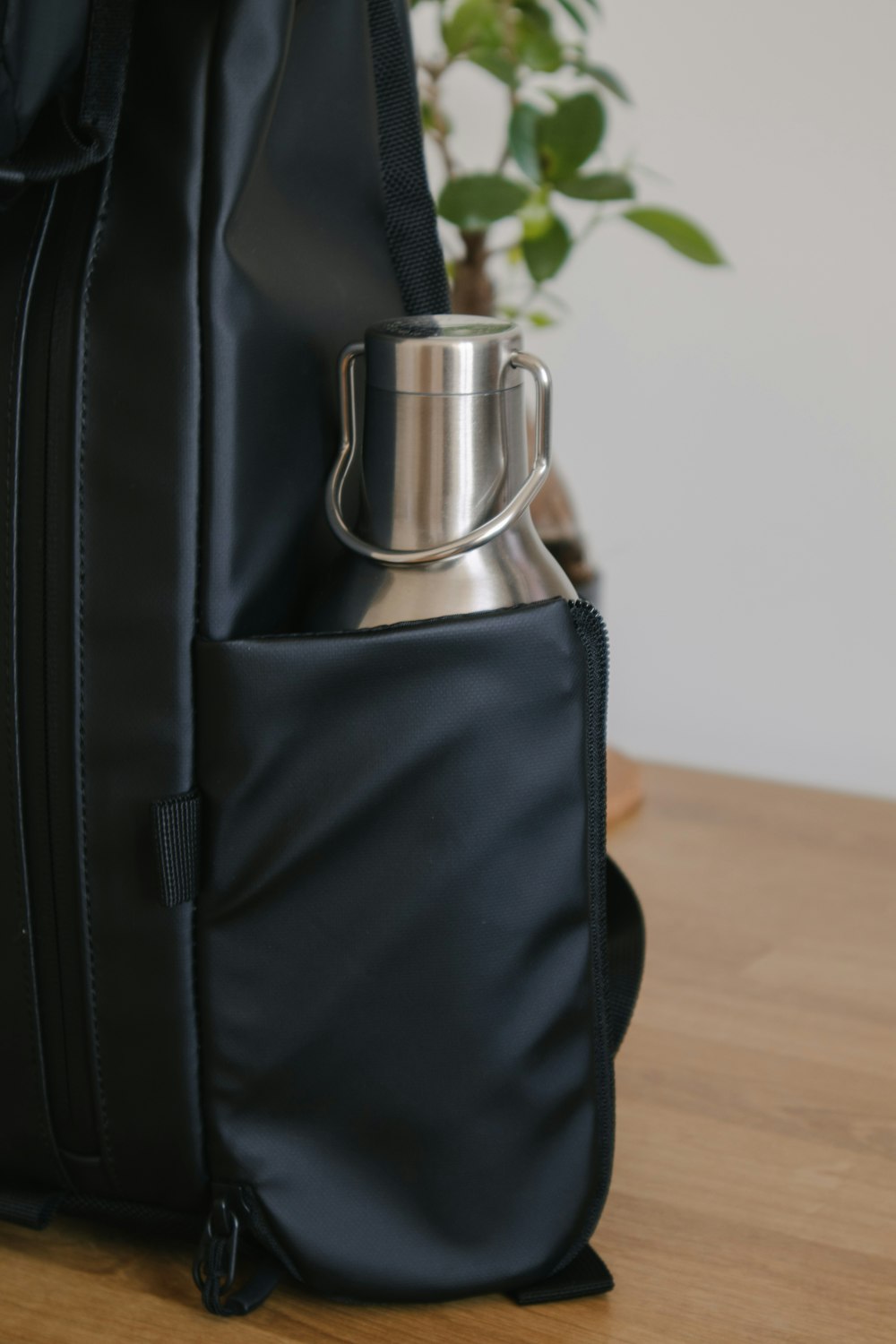 black leather bag on brown wooden table
