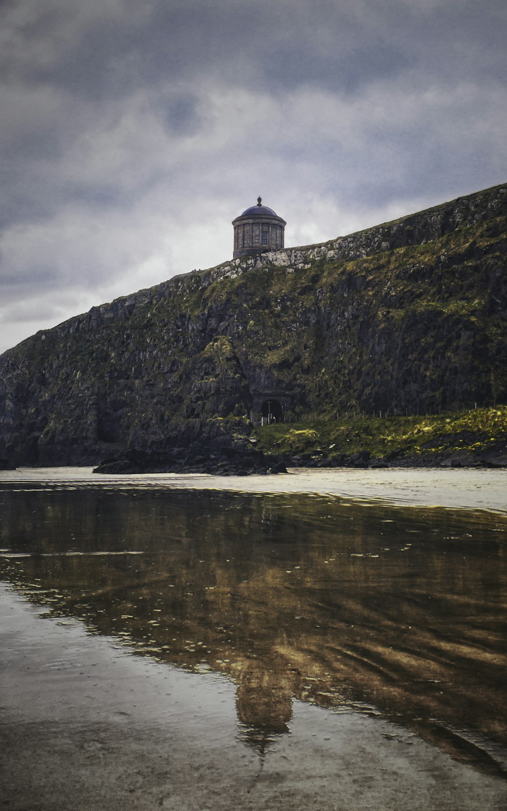 white and black concrete building near body of water during daytime