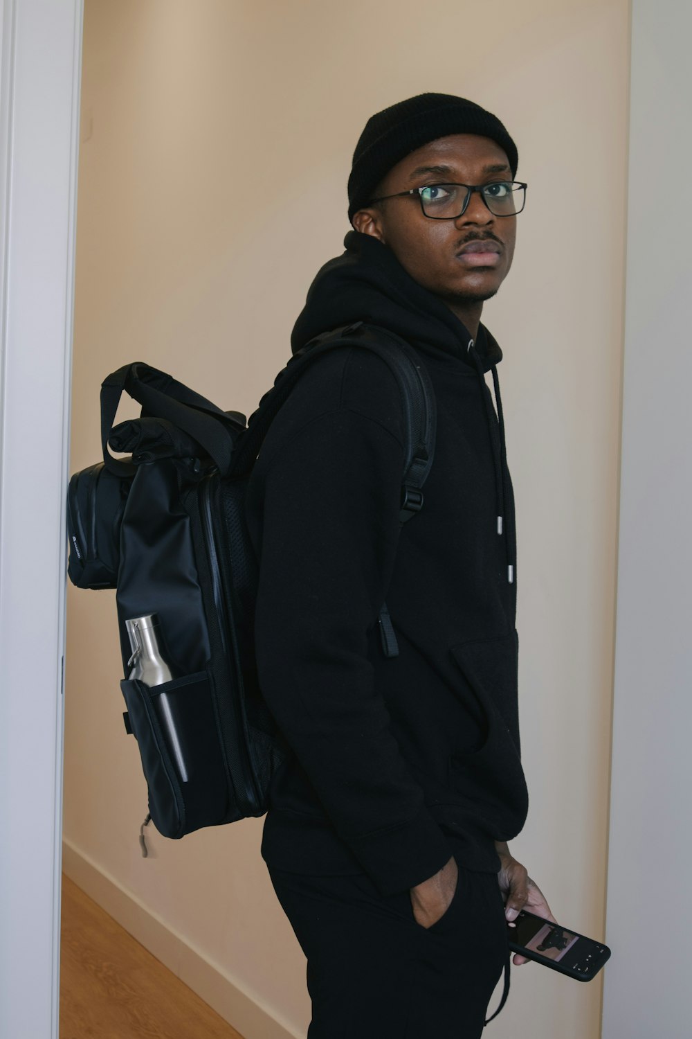 man in black hoodie wearing black sunglasses