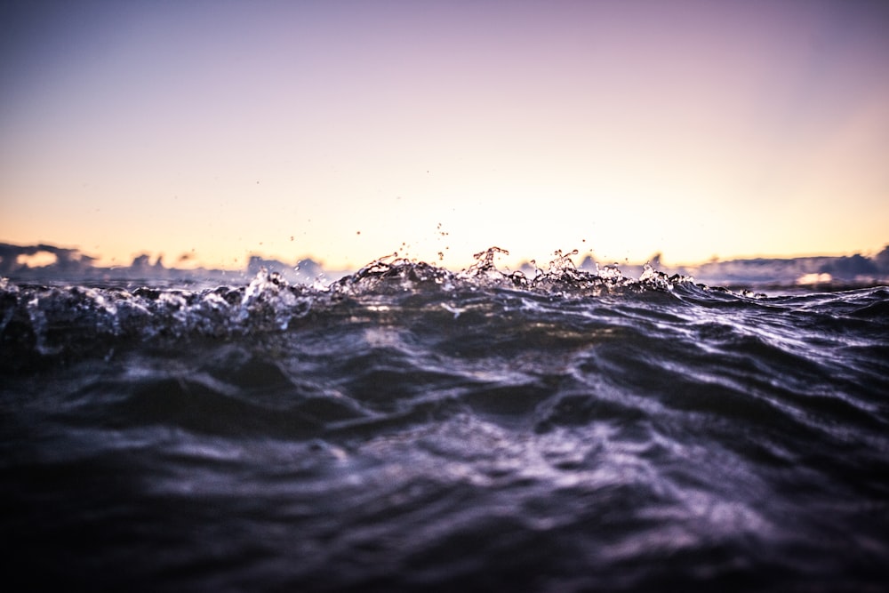 water waves under blue sky during daytime