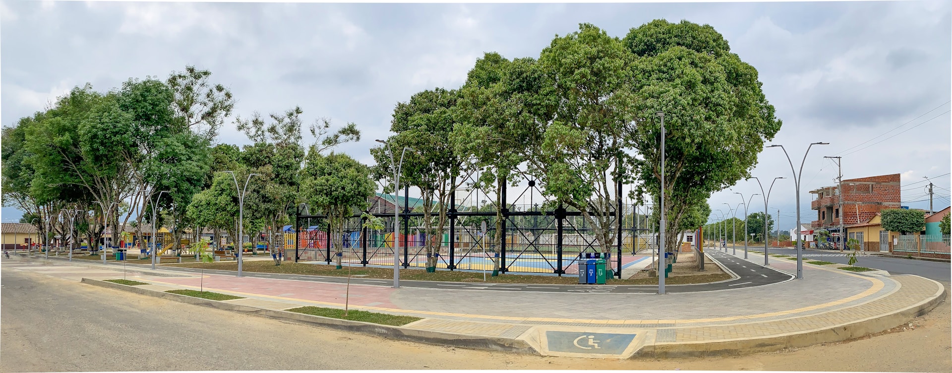 A beautifully landscaped community park nestled between newly completed homes, inviting families to gather.