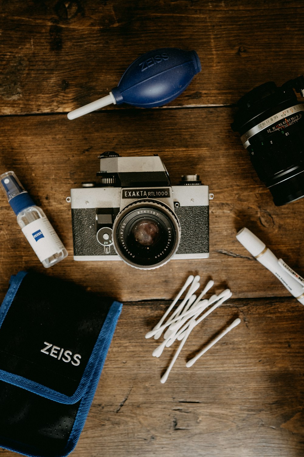 black and silver dslr camera beside white and black disposable lighter