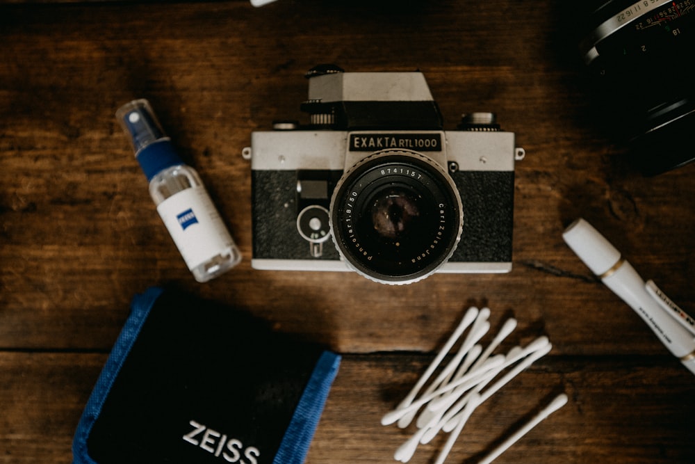 black and silver canon camera on brown wooden table