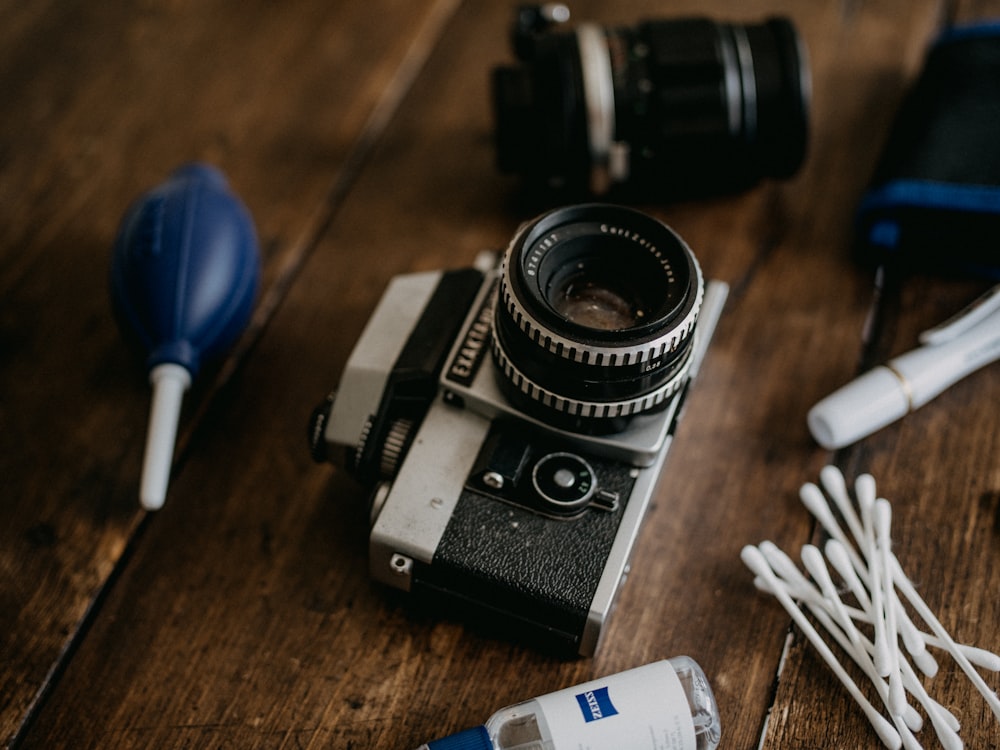 black and silver camera on brown wooden table