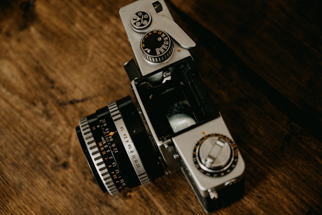 black and silver camera on brown wooden table