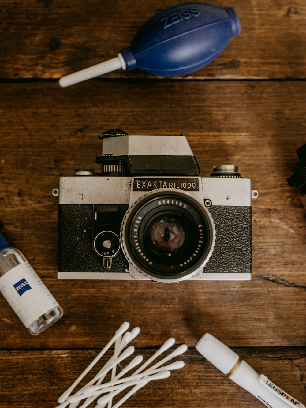 black and silver pentax camera on brown wooden table