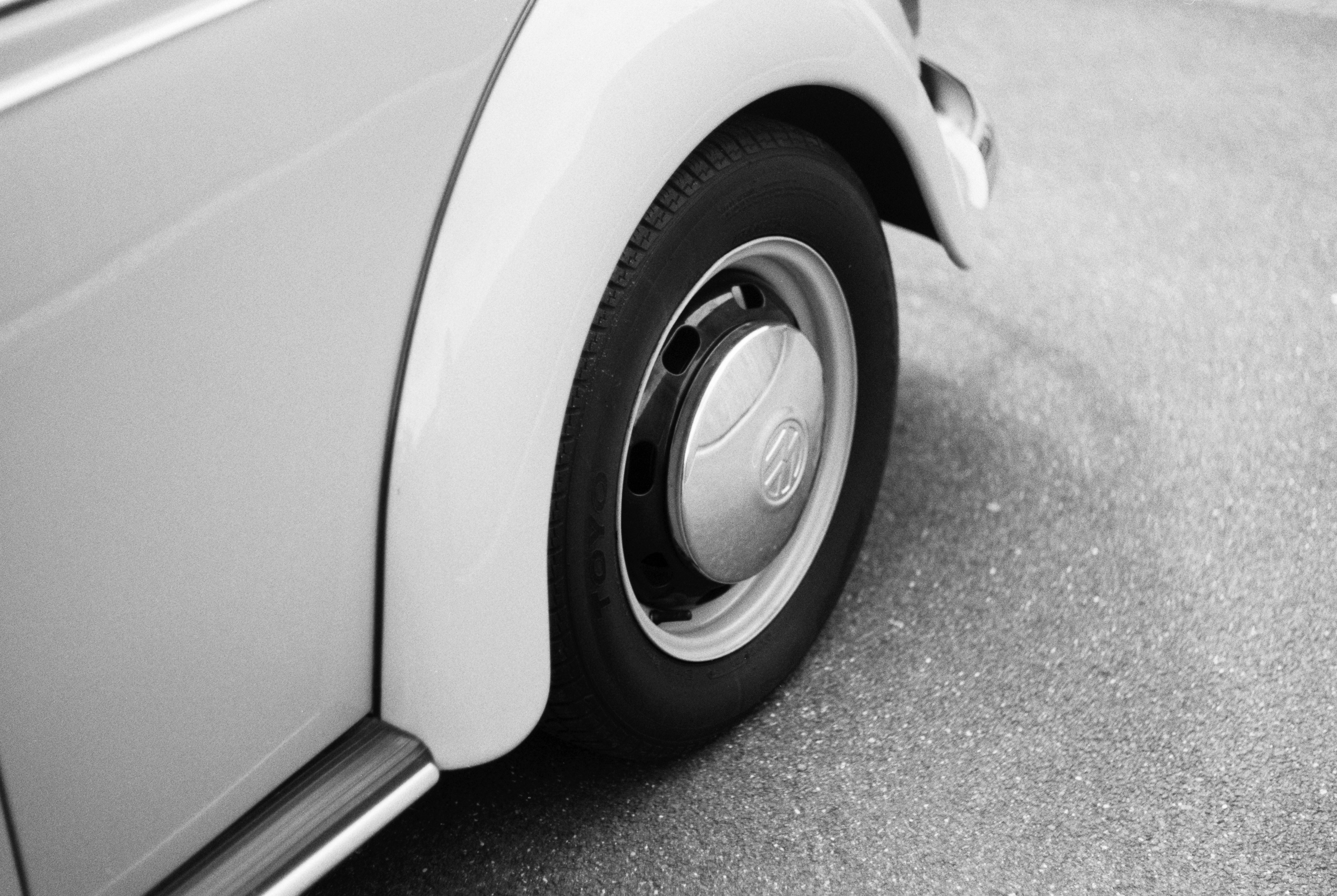 grayscale photo of car with wheel