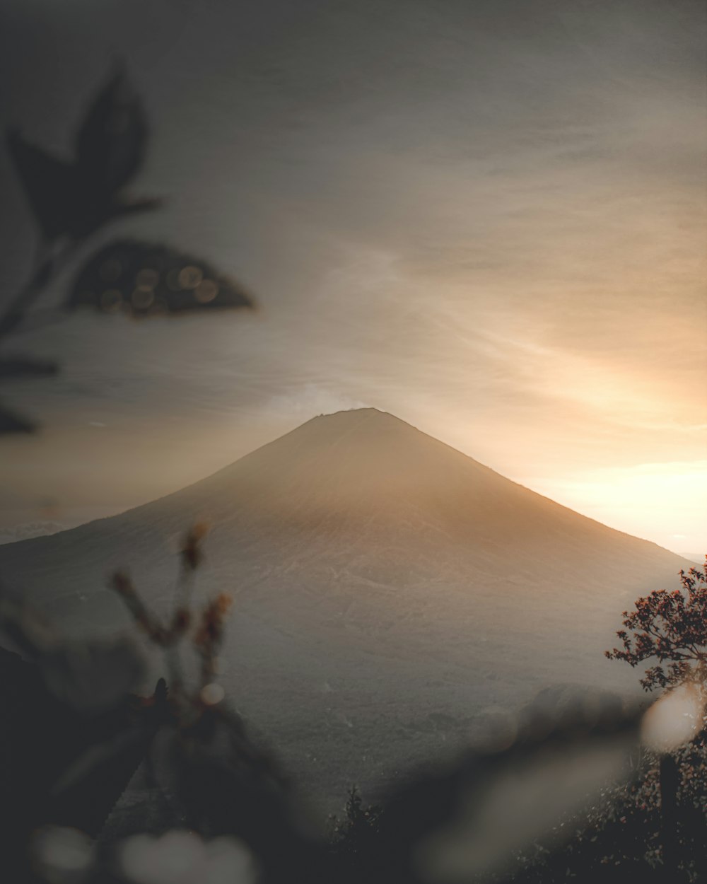 silhouette of mountain under cloudy sky during daytime