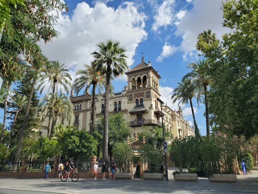 People walking on street near beige concrete building during daytime — Seville, Spain