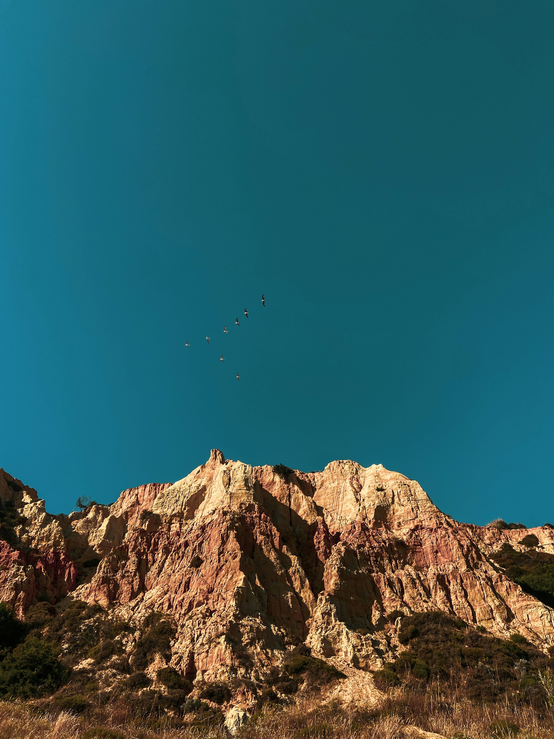 brown rocky mountain under blue sky during daytime