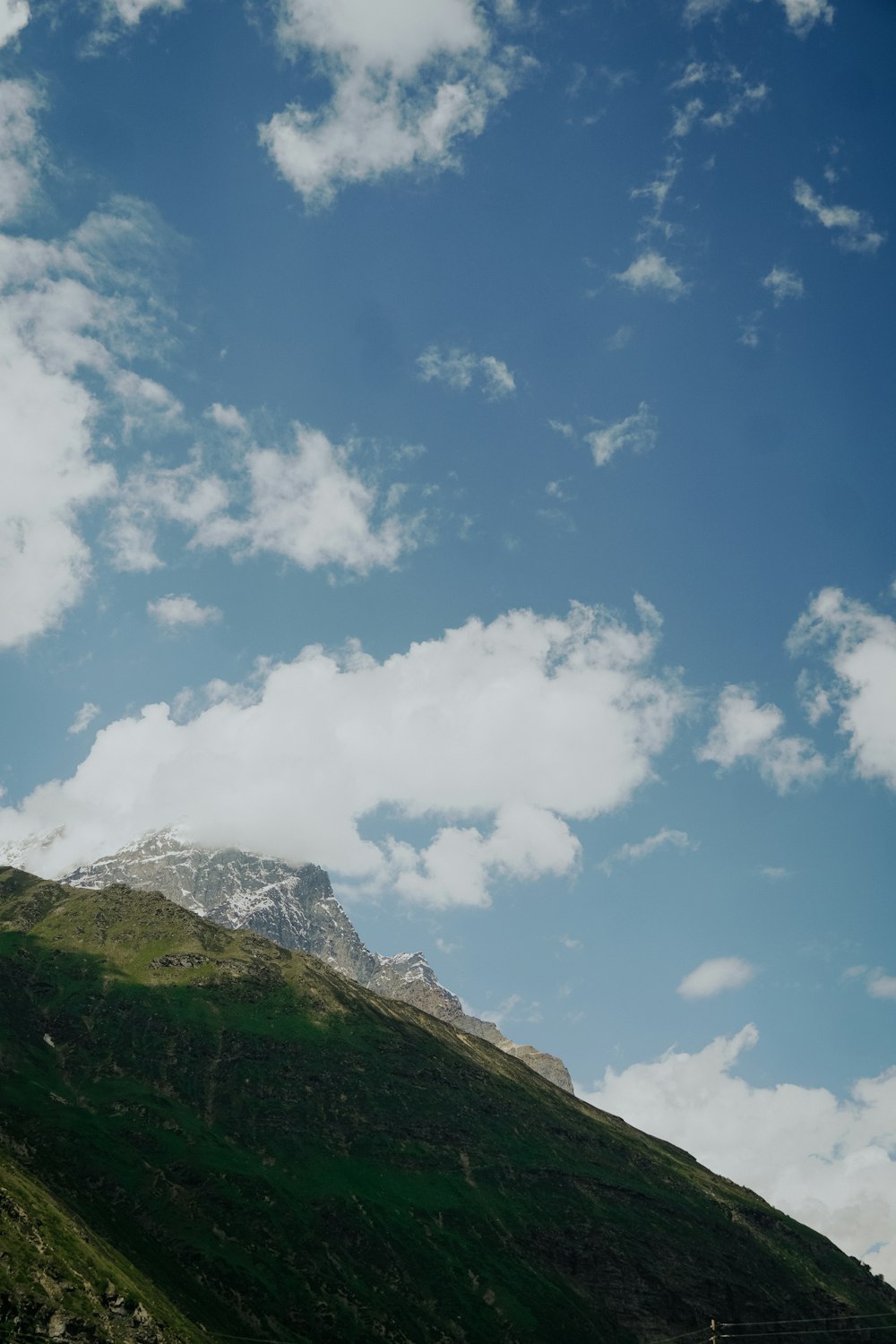 green and brown mountain under blue sky and white clouds during daytime