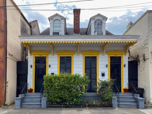 Exterior view of the duplex building with charming architecture and greenery.
