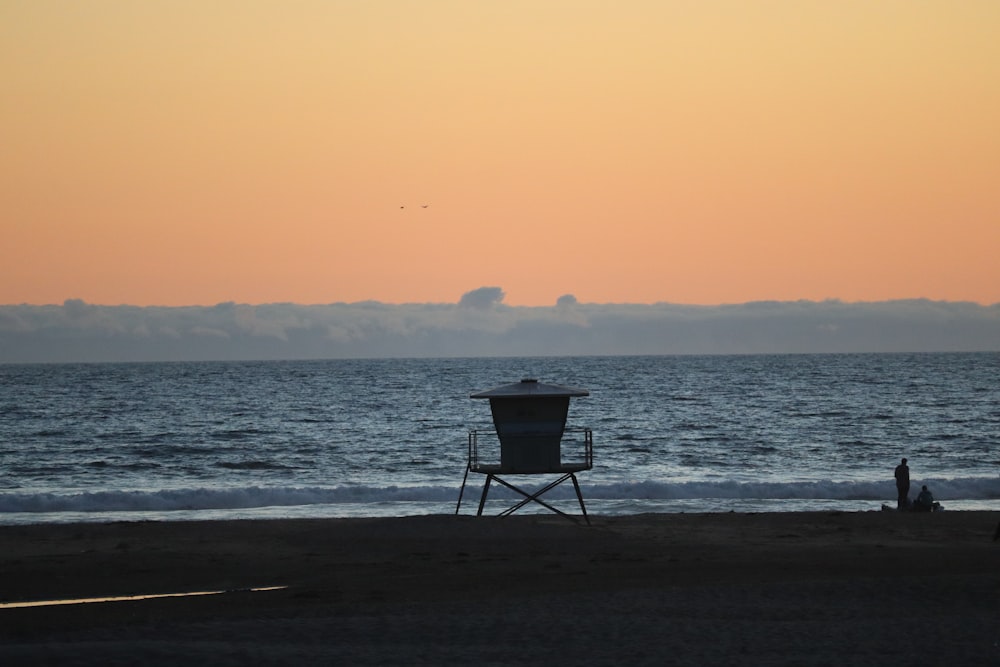 black wooden chair on beach during daytime