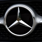 silver mercedes benz emblem on black car