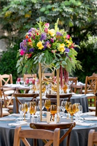 pink and yellow flowers on clear glass vase