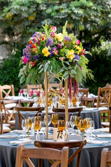pink and yellow flowers on clear glass vase