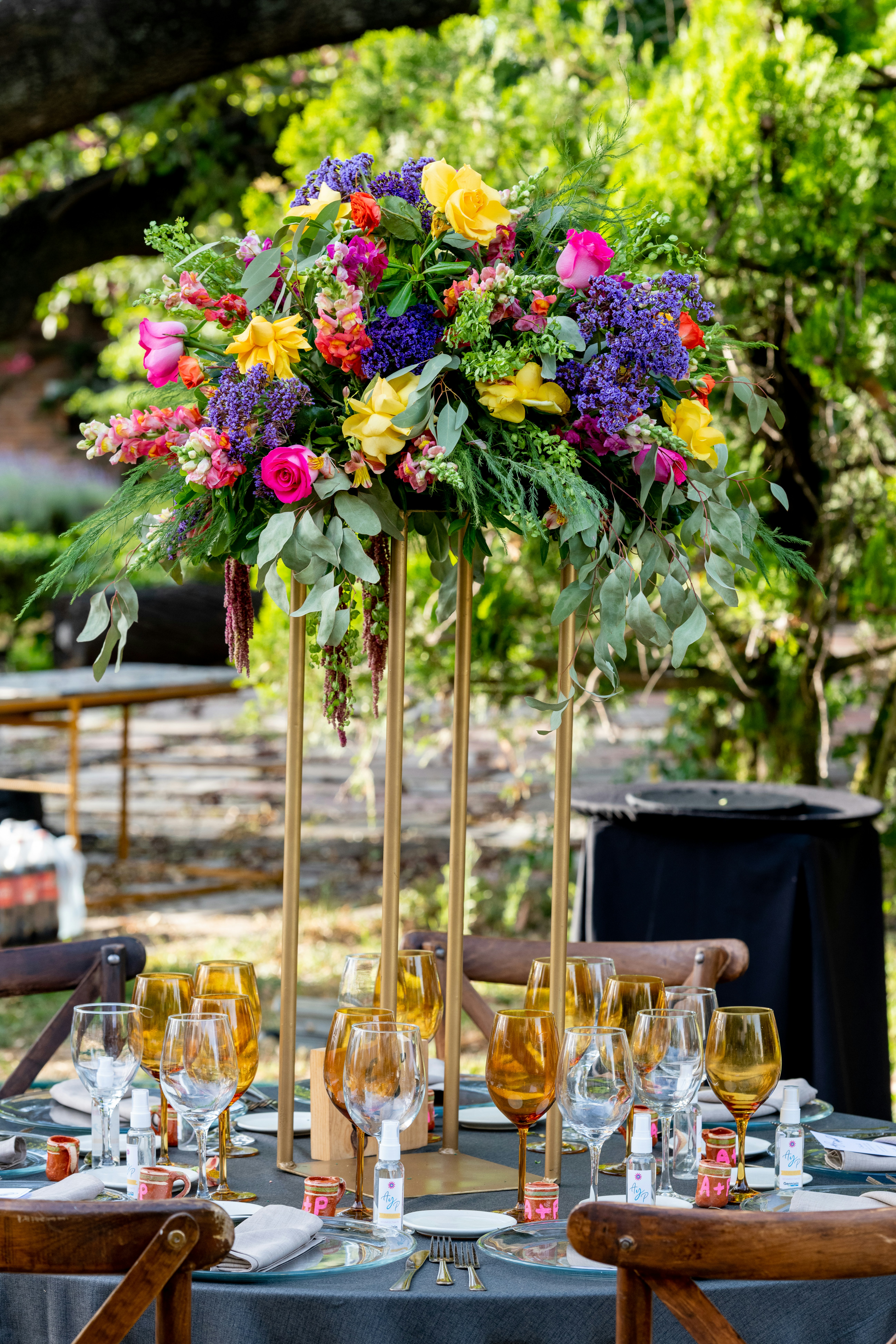 Golden anniversary celebration with warm amber lighting, floral centerpieces and champagne glasses