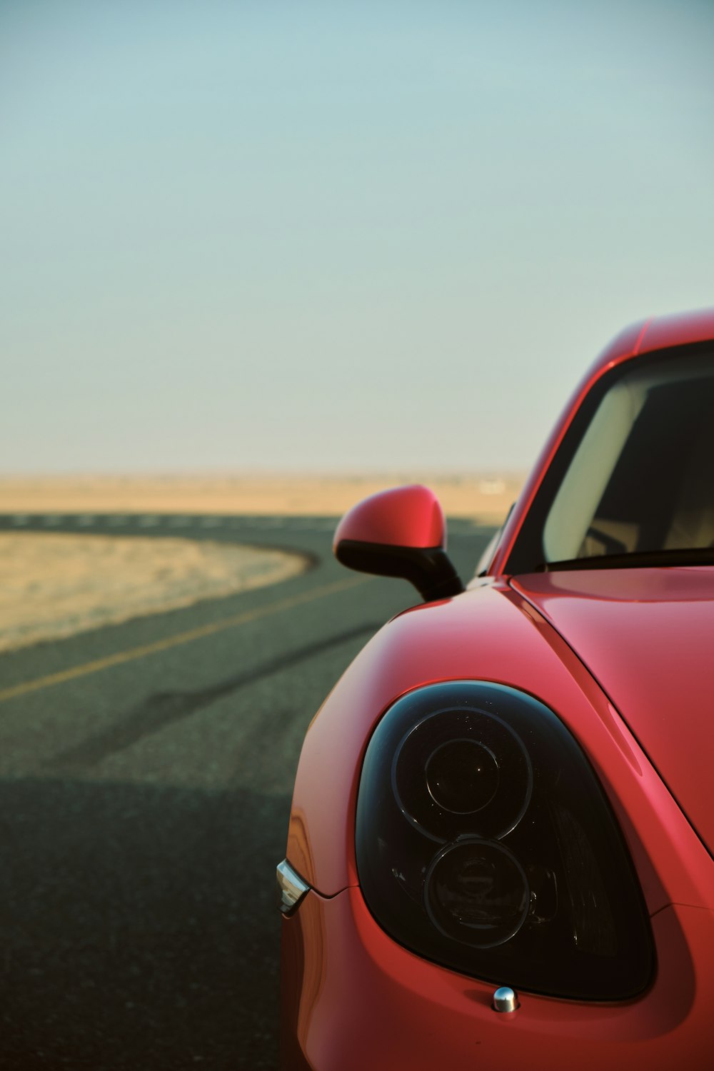 red volkswagen beetle on road during daytime