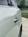Close-up of a clean white delivery van with water droplets glistening after washing.