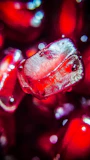 Close-up of glossy red pomegranates with droplets of water highlighting their freshness.