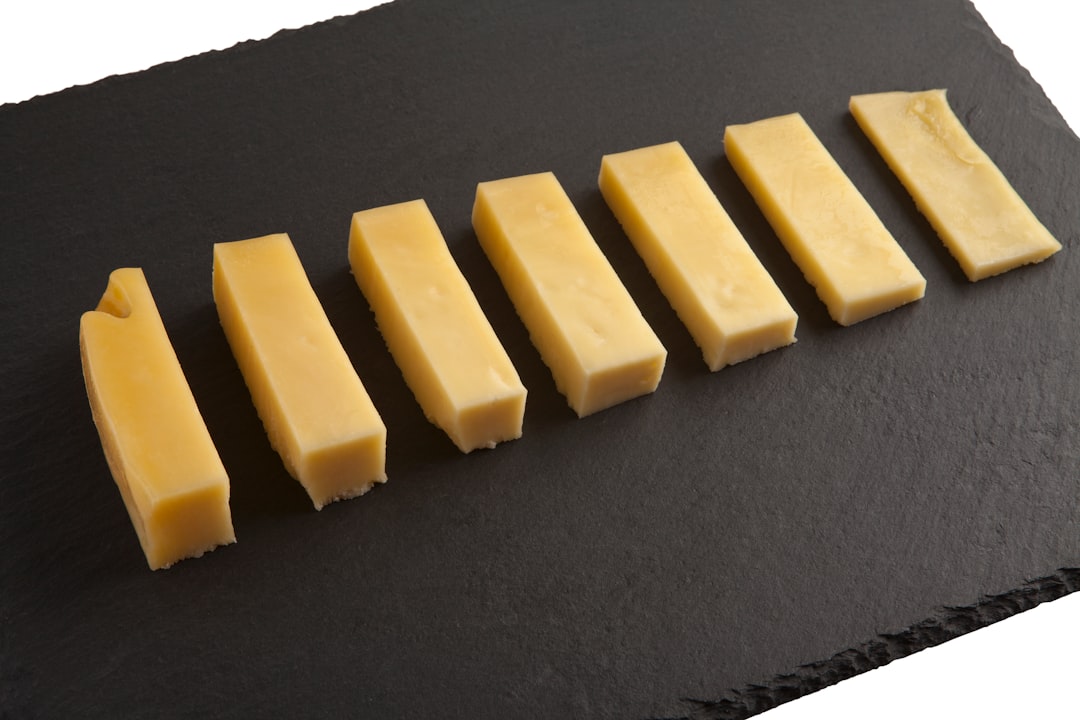 yellow cheese on black textile