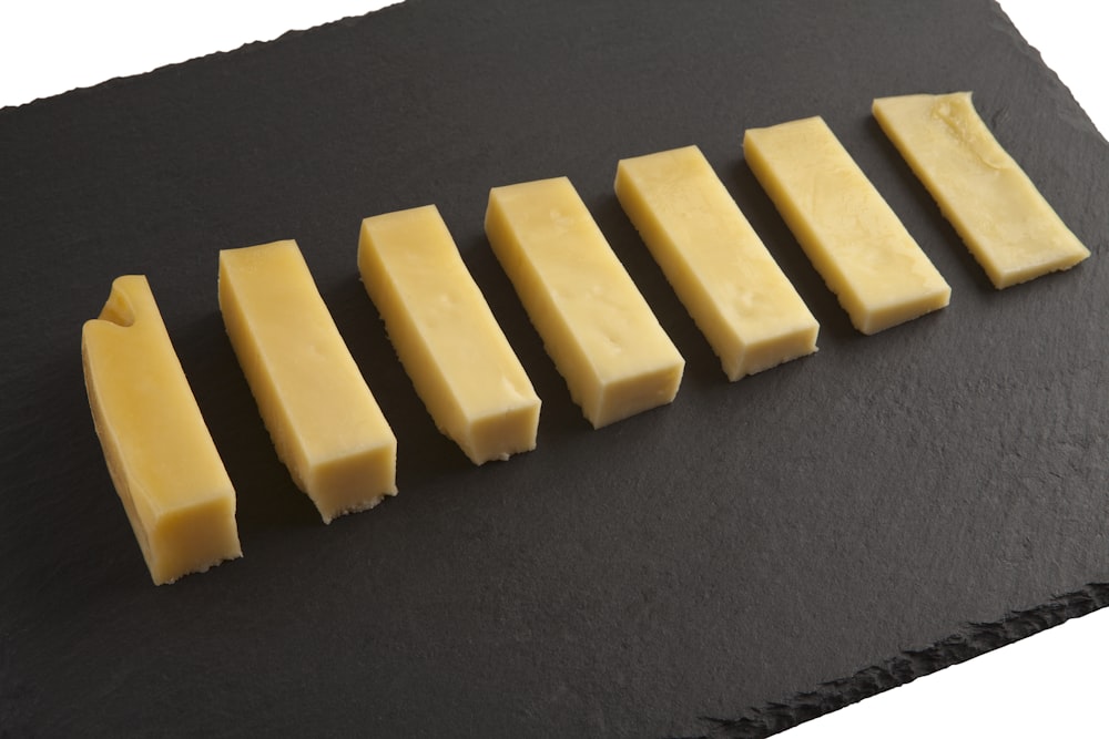 yellow cheese on black textile