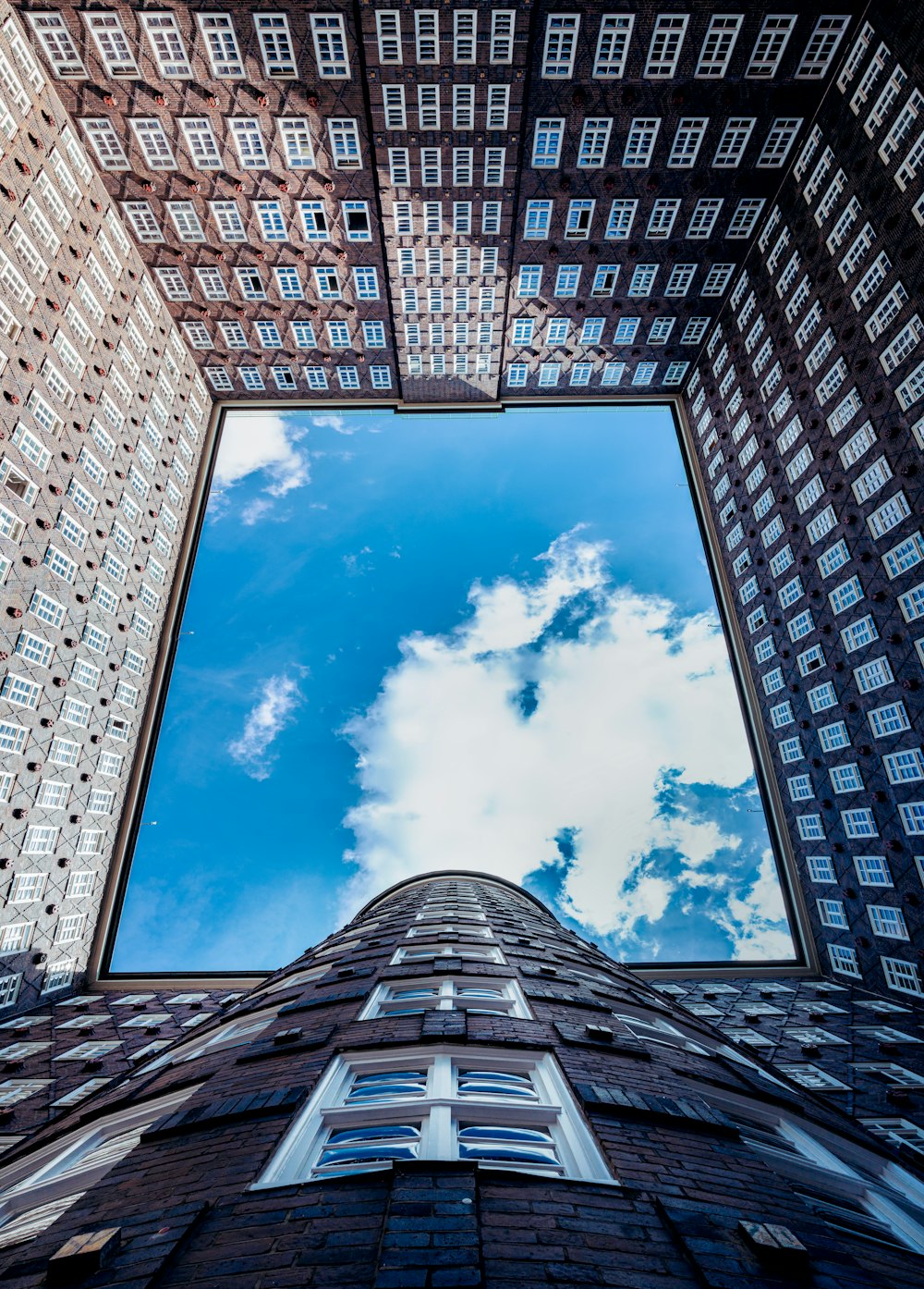 worms eye view of white clouds and blue sky during daytime