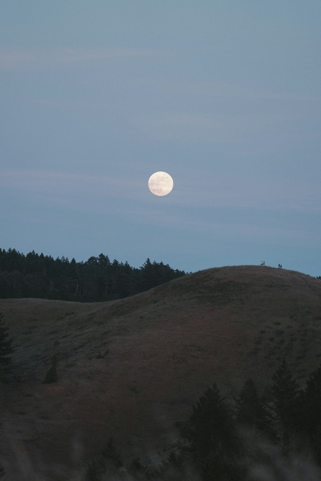 full moon over green mountain