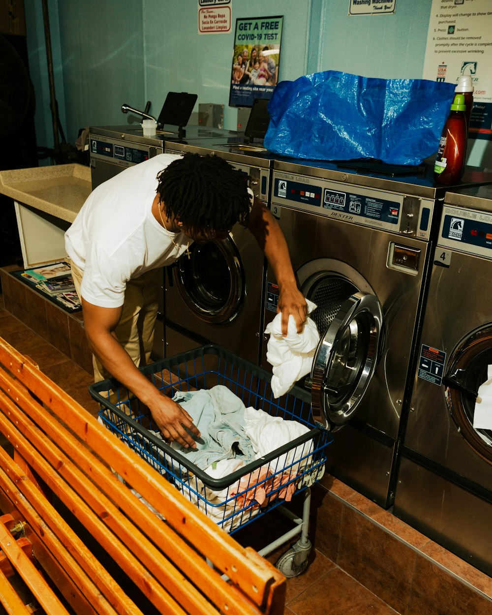 woman in white t-shirt washing dishes