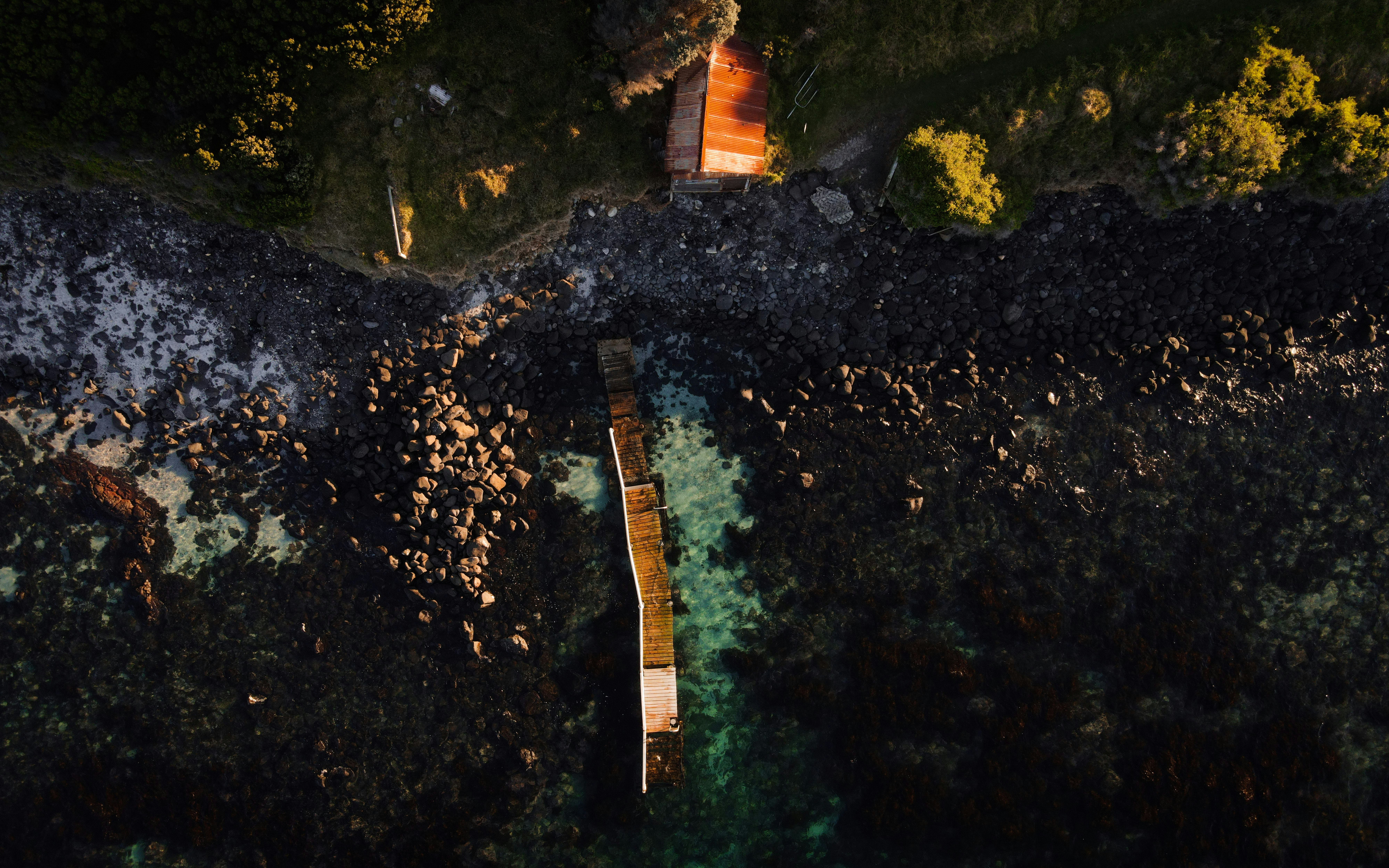 brown wooden dock on body of water