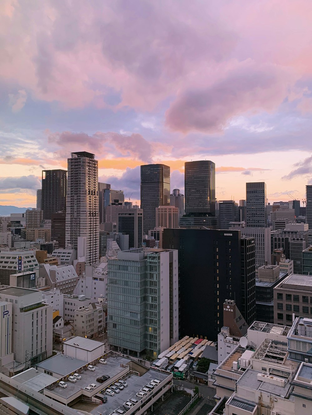 high rise buildings under white clouds during daytime