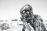 Wide shot of an outdoor installation featuring large assemblages of repurposed mechanical objects arranged artistically.