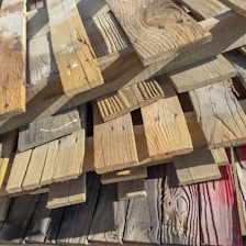 Photo of stacked wooden planks ready for construction use.
