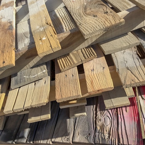 Photo of stacked wooden planks ready for construction use.