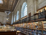 brown wooden book shelves in library