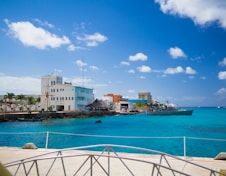 white and brown concrete building near body of water during daytime