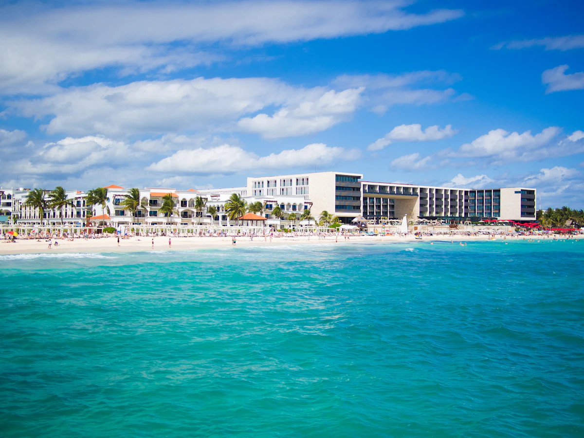 Palm trees and turquoise Caribbean water on a beach at Playa del Carmen