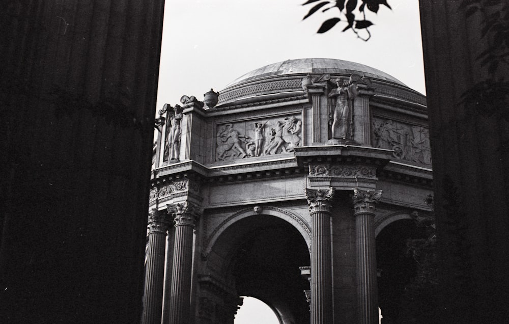 gray concrete arch under white sky during daytime