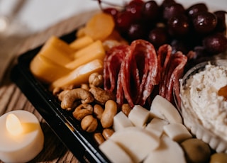 sliced cheese and meat on black ceramic plate