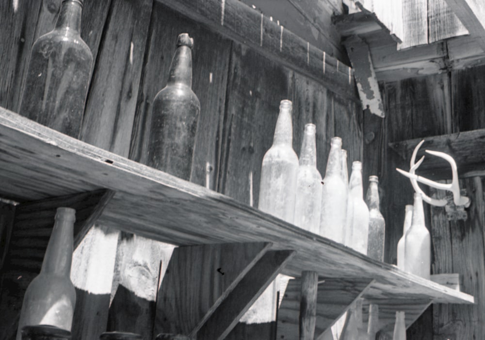 clear glass bottles on brown wooden table