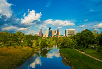 A vibrant city skyline with green spaces and modern buildings.