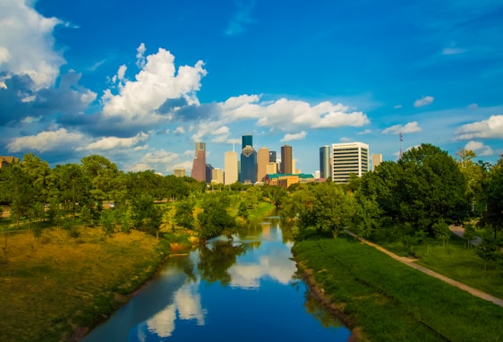 A vibrant city skyline with green spaces and modern buildings.