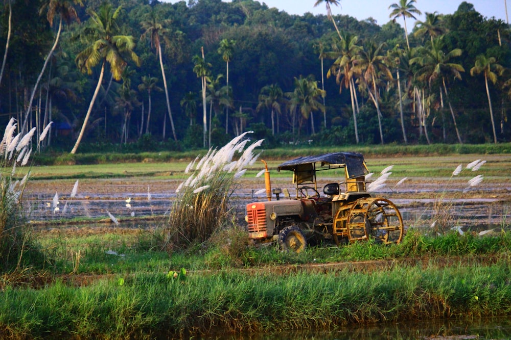 brown and black tractor on green grass field during daytime